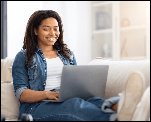 Relaxed woman on couch with laptop